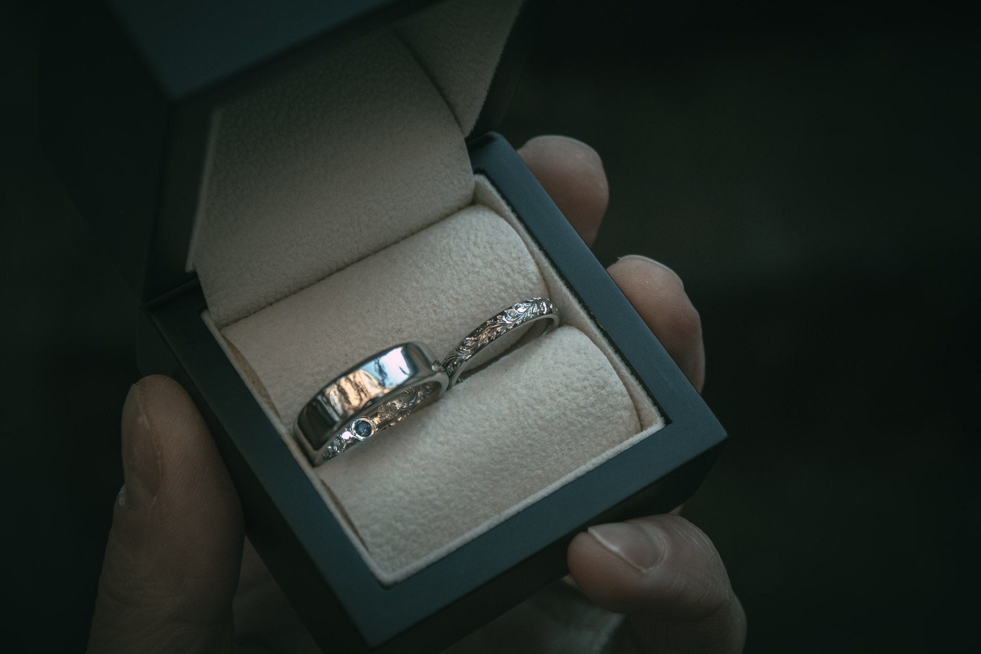Bespoke engraved platinum wedding rings with hidden sapphire