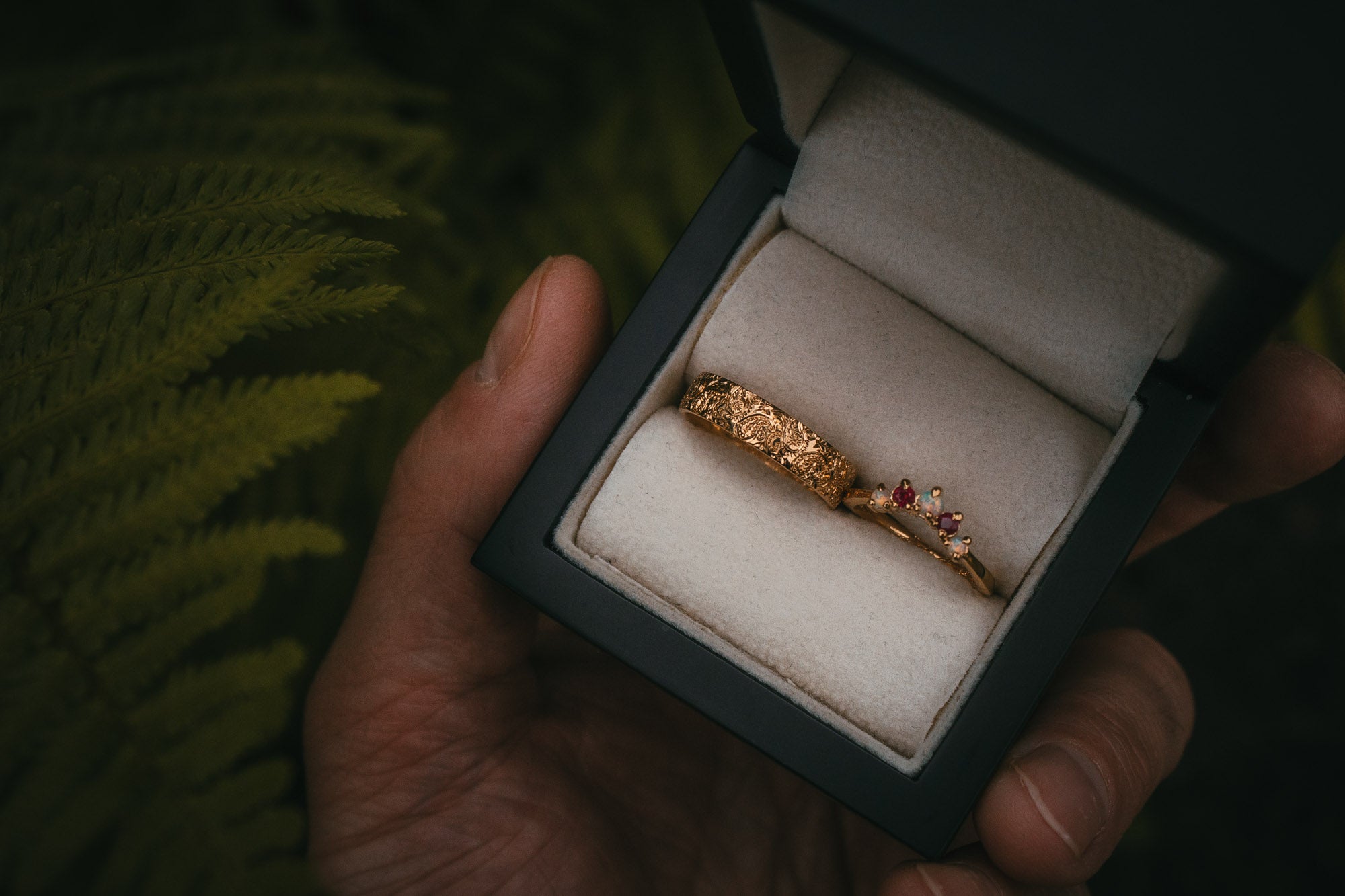 Engraved paisley pattern wedding band with fitted ruby and opal wedding ring