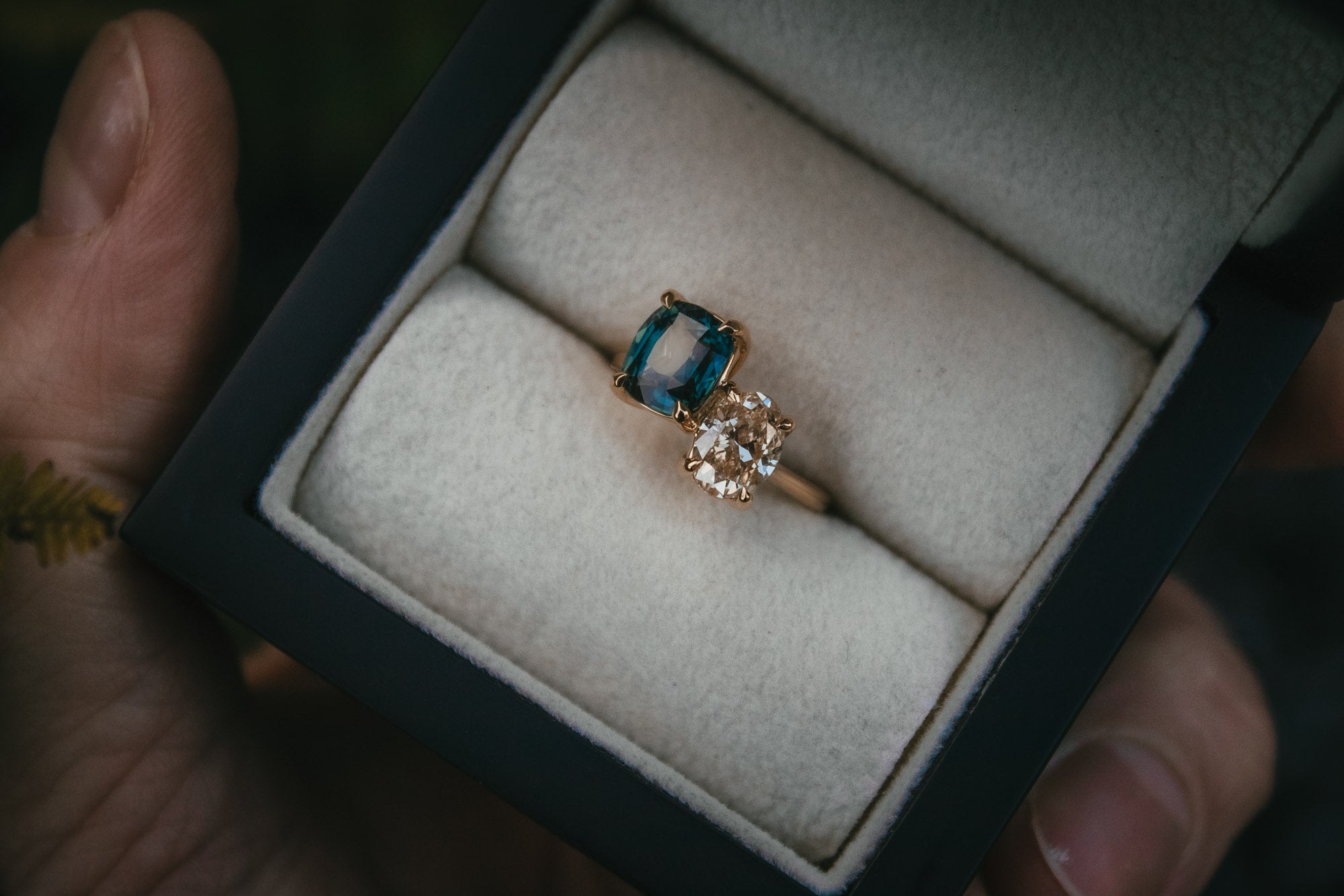 Warm white diamond and teal sapphire toi et moi engagement ring
