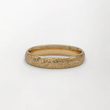 Hand engraved Scottish wildflowers wedding ring product shot on white