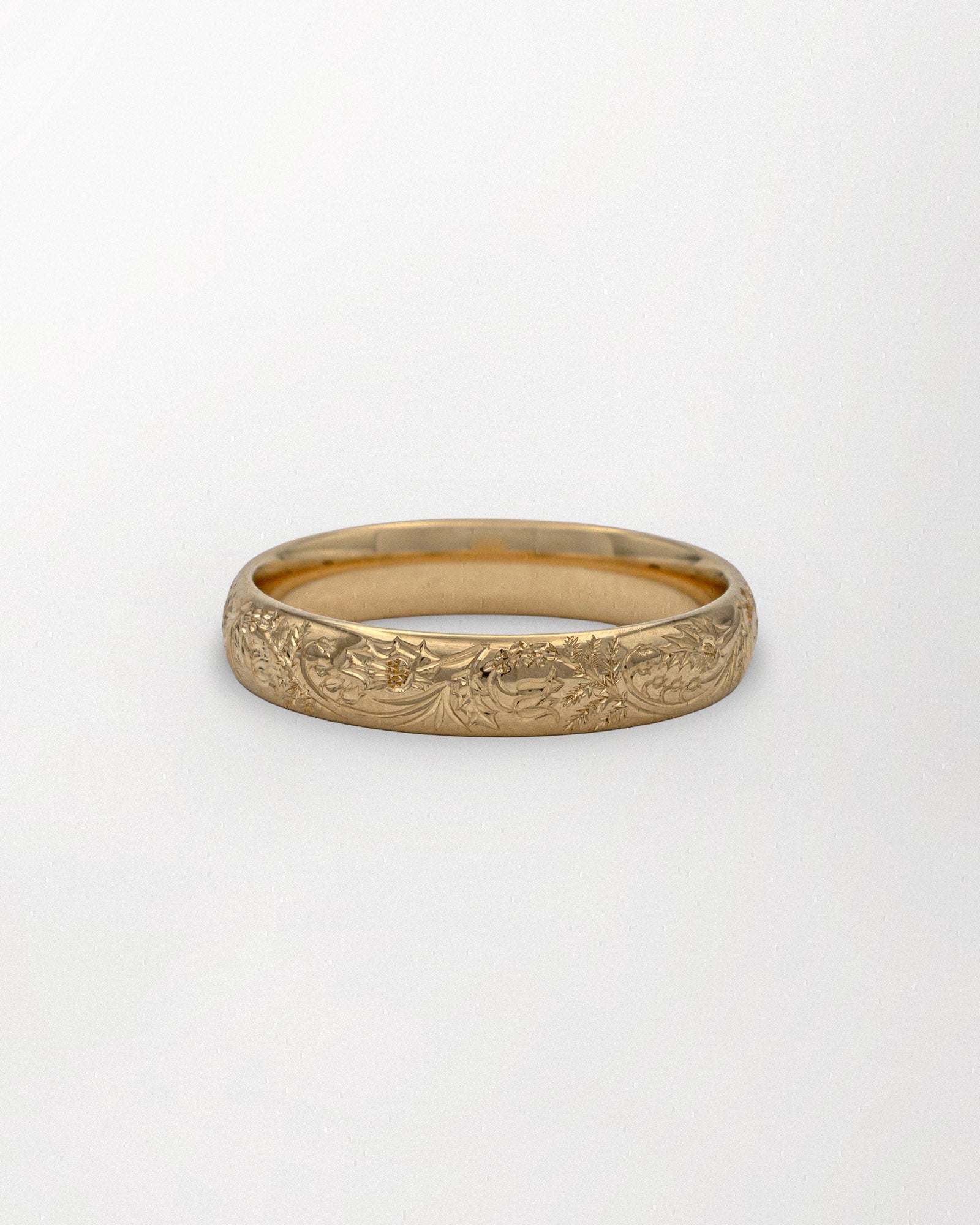 Hand engraved Scottish wildflowers wedding ring product shot on white