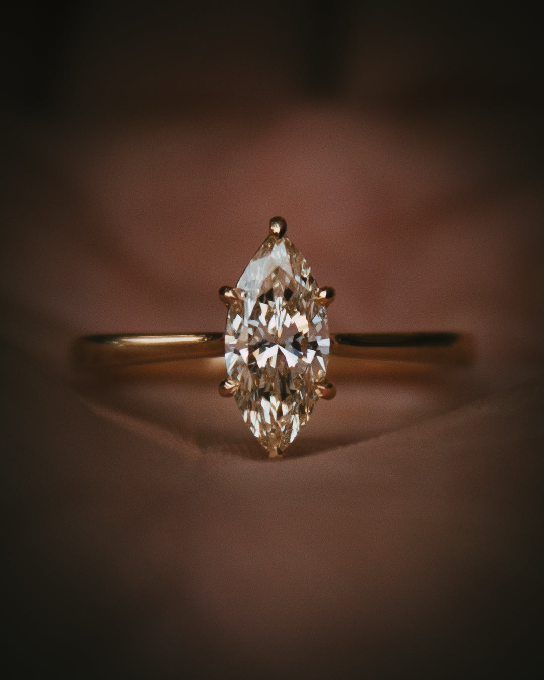 Uist marquise natural diamond solitaire ring in 18ct yellow gold; detail in hand