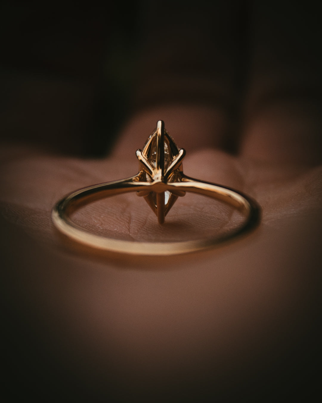 Uist marquise warm white natural diamond solitaire ring in 18ct yellow gold view from bottom Arc setting detail