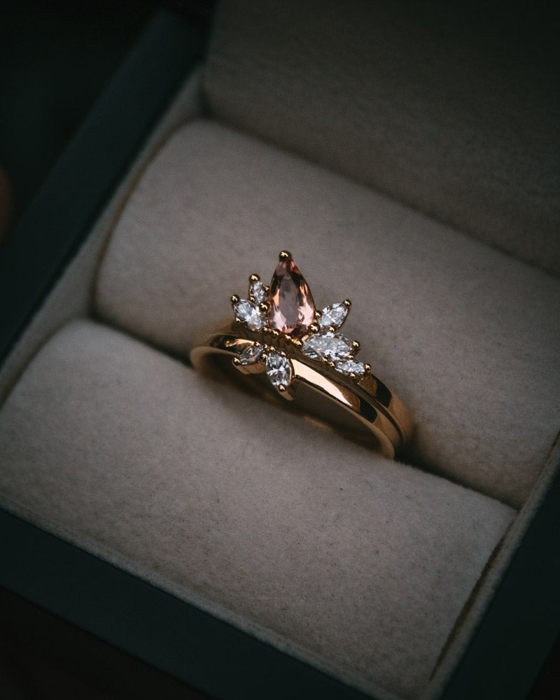 Fara ring set an asymmetric peach topaz engagement ring paired with a fitted diamond wedding ring by Moira Patience Fine Jewellery