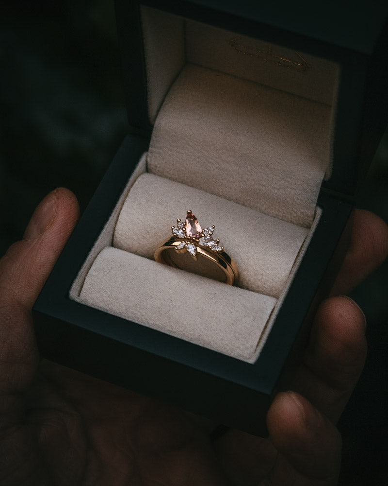 Fara ring set an asymmetric peach topaz engagement ring paired with a fitted diamond wedding ring by Moira Patience Fine Jewellery
