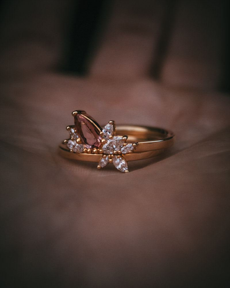 Fara ring set an asymmetric peach topaz engagement ring paired with a fitted diamond wedding ring by Moira Patience Fine Jewellery