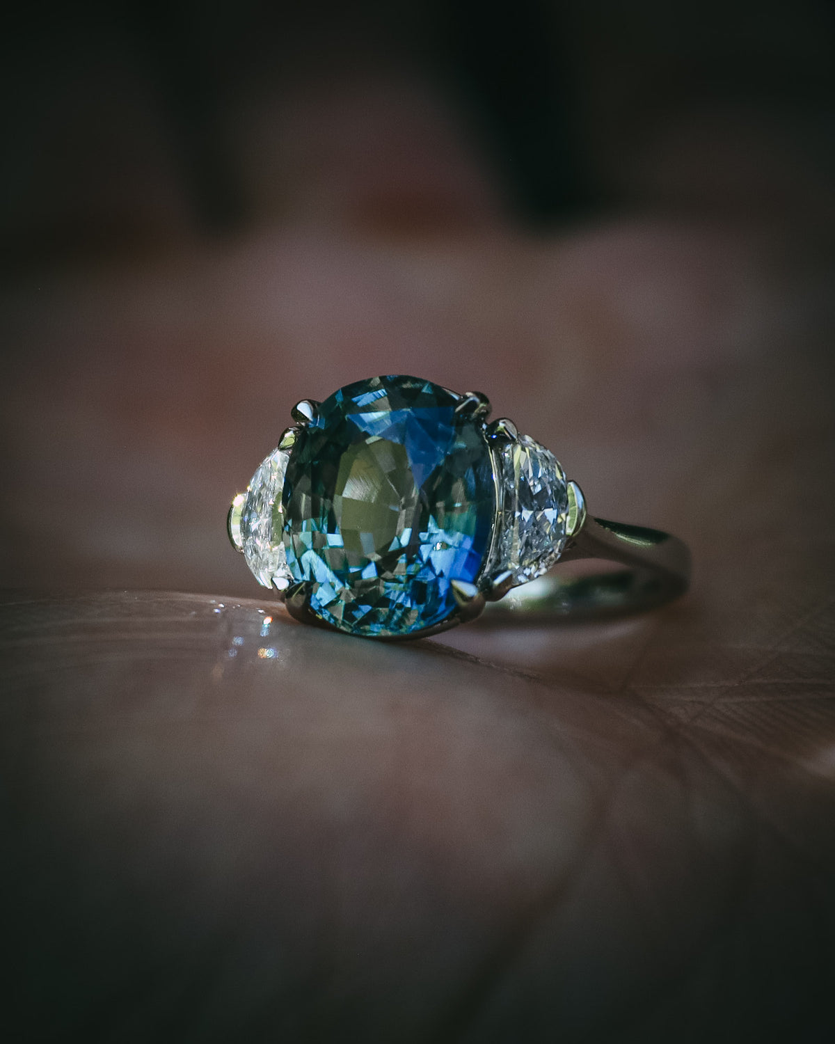 Ghlas oval teal sapphire and half-moon diamond ring in platinum, gemstone close-up