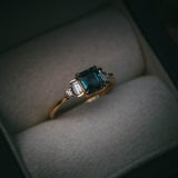 Fine jewellery ring featuring a teal sapphire and diamond accents, crafted in Scotland by Moira Patience