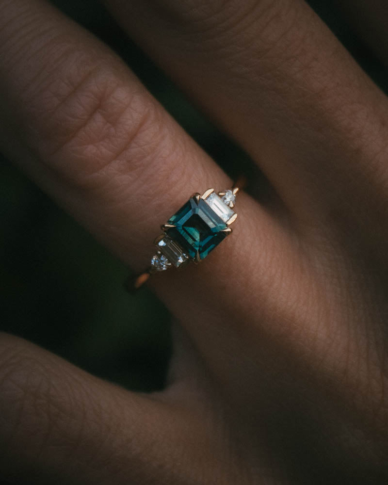 Fine jewellery ring featuring a teal sapphire and diamond accents, crafted in Scotland by Moira Patience