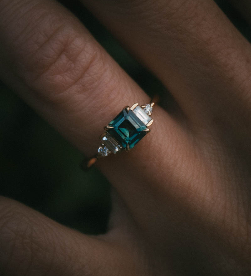 Fine jewellery ring featuring a teal sapphire and diamond accents, crafted in Scotland by Moira Patience
