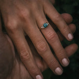 Fine jewellery ring featuring a teal sapphire and diamond accents, crafted in Scotland by Moira Patience