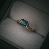 Fine jewellery ring featuring a teal sapphire and diamond accents, crafted in Scotland by Moira Patience