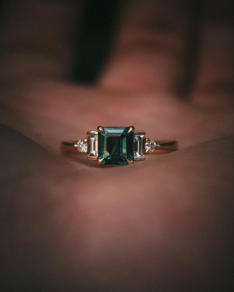 Fine jewellery ring featuring a teal sapphire and diamond accents, crafted in Scotland by Moira Patience