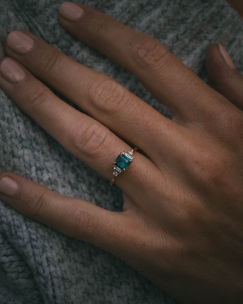 Fine jewellery ring featuring a teal sapphire and diamond accents, crafted in Scotland by Moira Patience