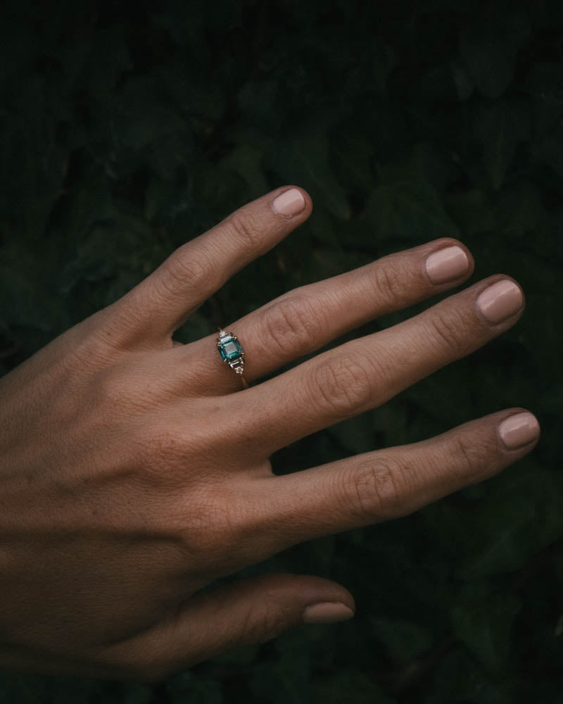 Fine jewellery ring featuring a teal sapphire and diamond accents, crafted in Scotland by Moira Patience