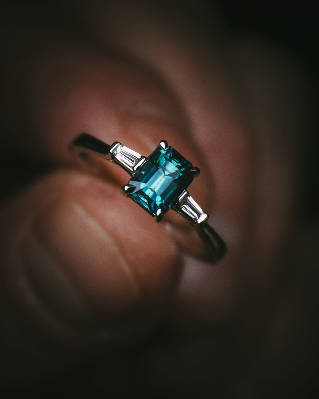 Sròn octagon step-cut teal sapphire ring in platinum with tapered baguette diamonds