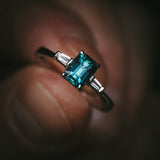 Sròn octagon step-cut teal sapphire ring in platinum with tapered baguette diamonds