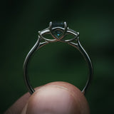 Sròn teal sapphire three-stone ring; platinum Arc setting side profile