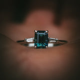 Sròn octagon step-cut teal sapphire ring front view in hand