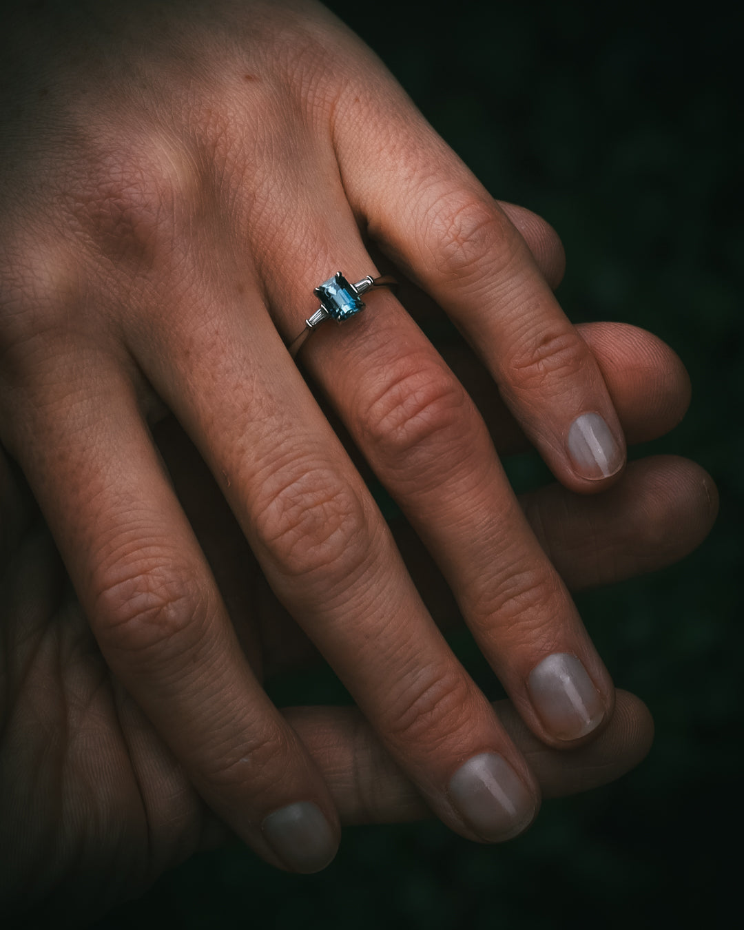 Sròn octagon step-cut teal sapphire ring on hand