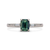 Sròn octagon step-cut teal sapphire ring; studio shot on white