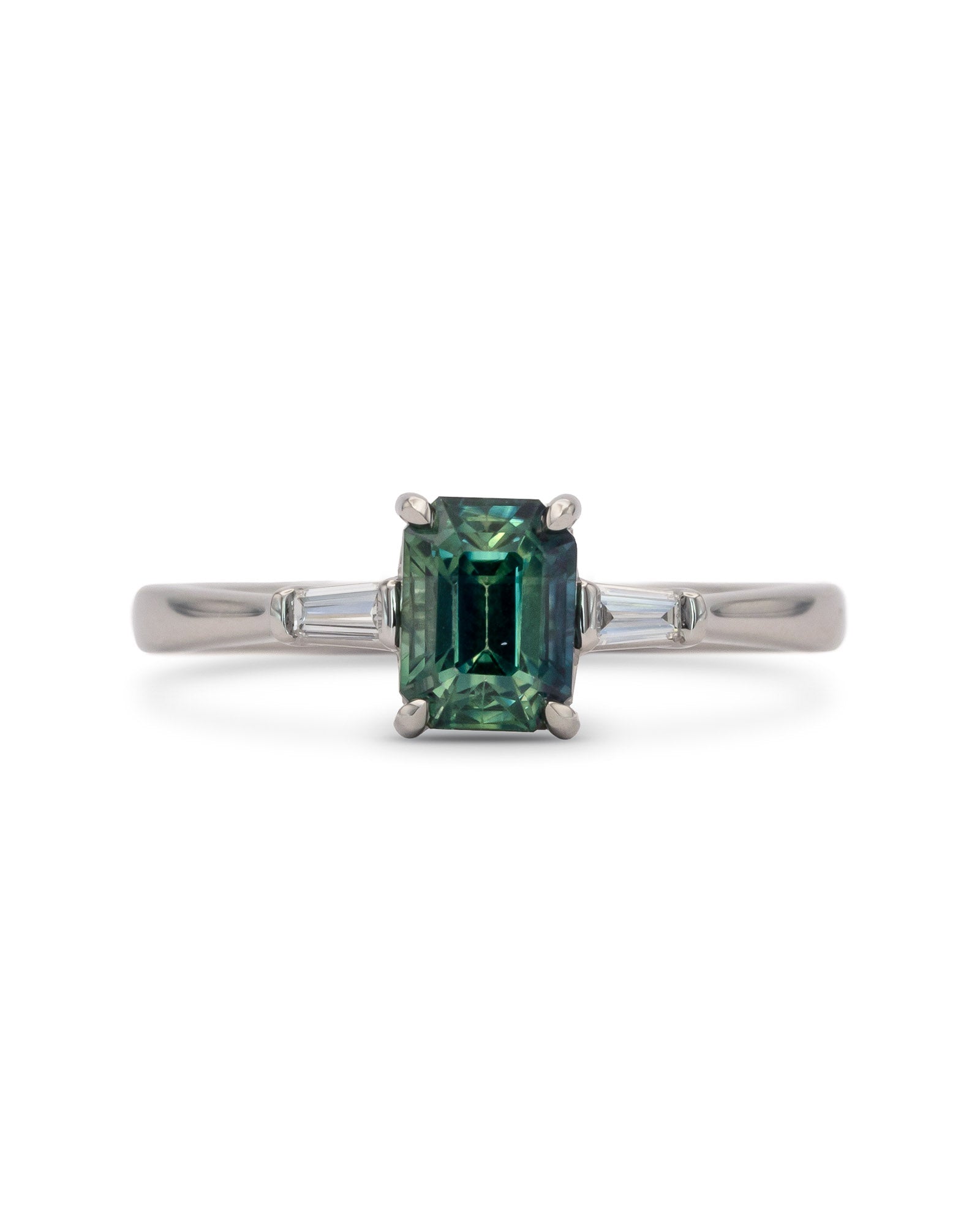 Sròn octagon step-cut teal sapphire ring; studio shot on white