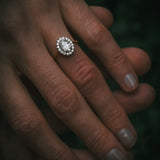 Flùr oval diamond cluster ring on hand; 1.00ct GIA certificated centre diamond