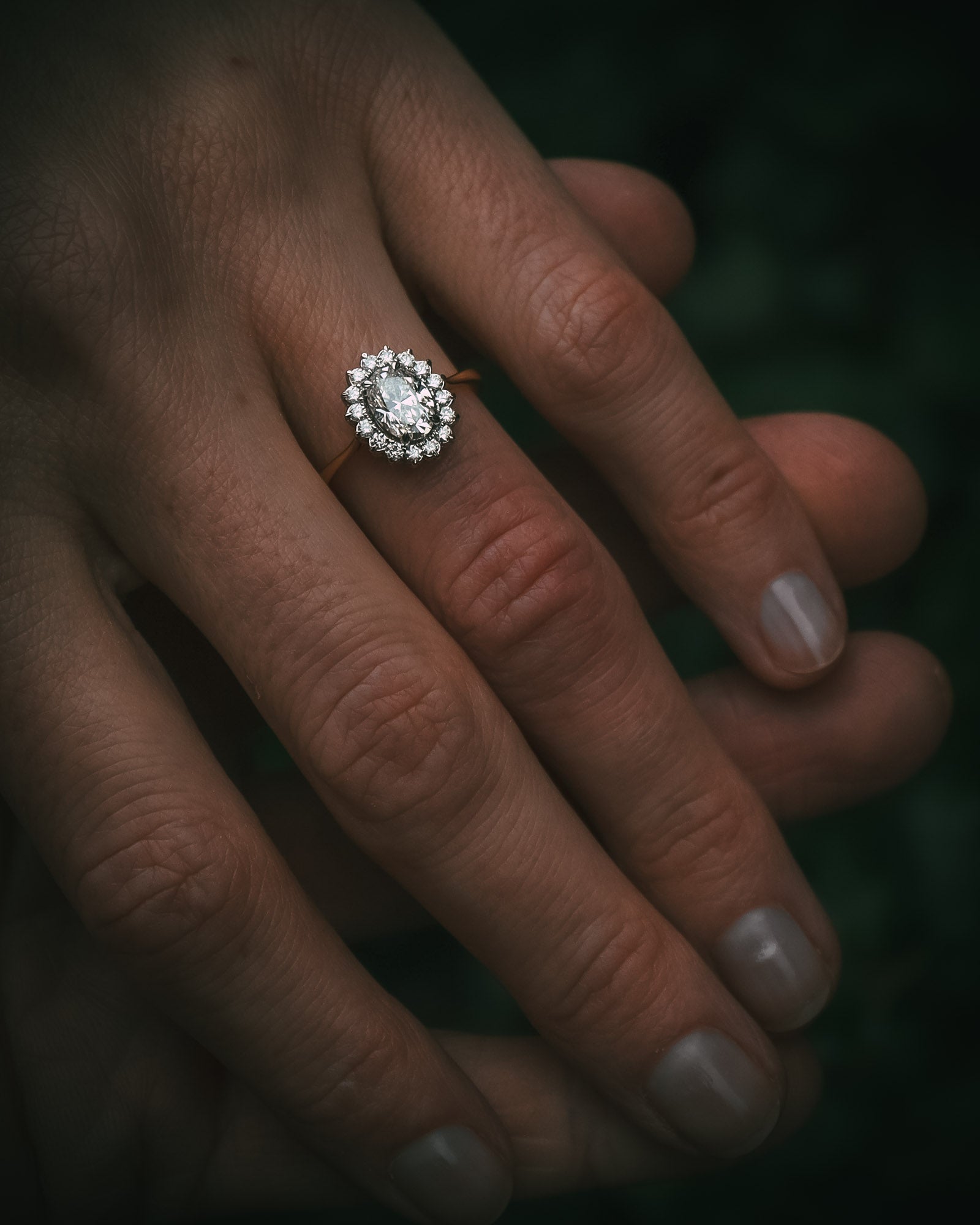 Flùr oval diamond cluster ring on hand; 1.00ct GIA certificated centre diamond