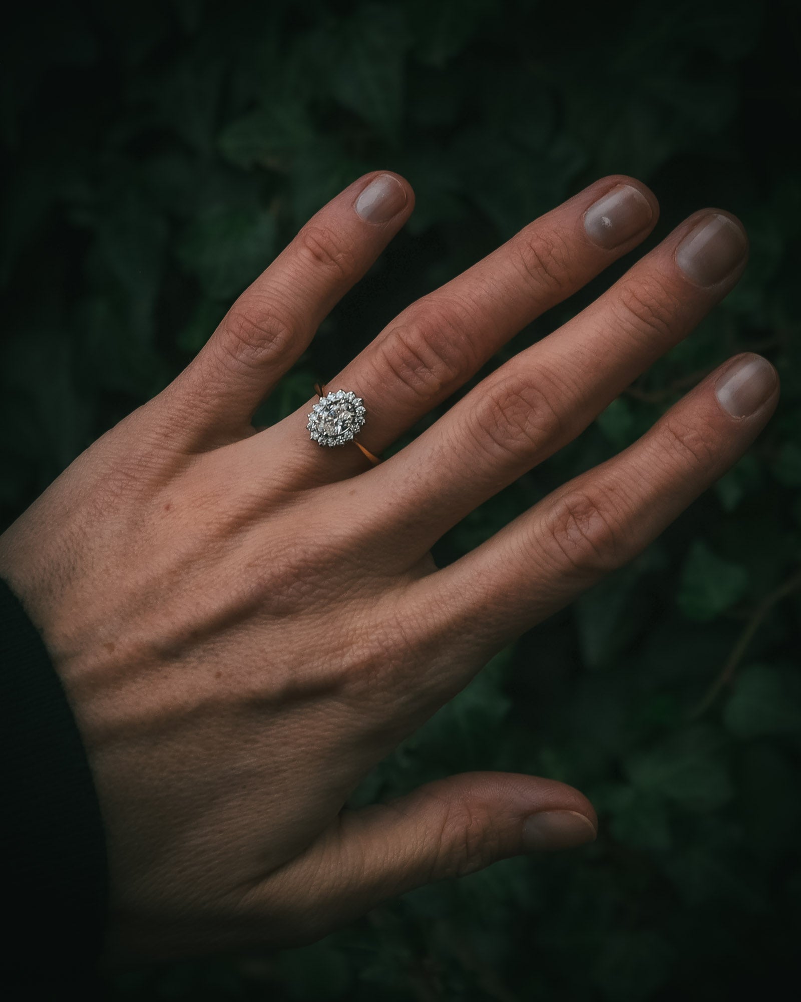 Flùr oval diamond cluster ring on hand; 1.00ct GIA certificated centre diamond