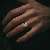 Flùr oval diamond cluster ring on hand; 1.00ct GIA certificated centre diamond