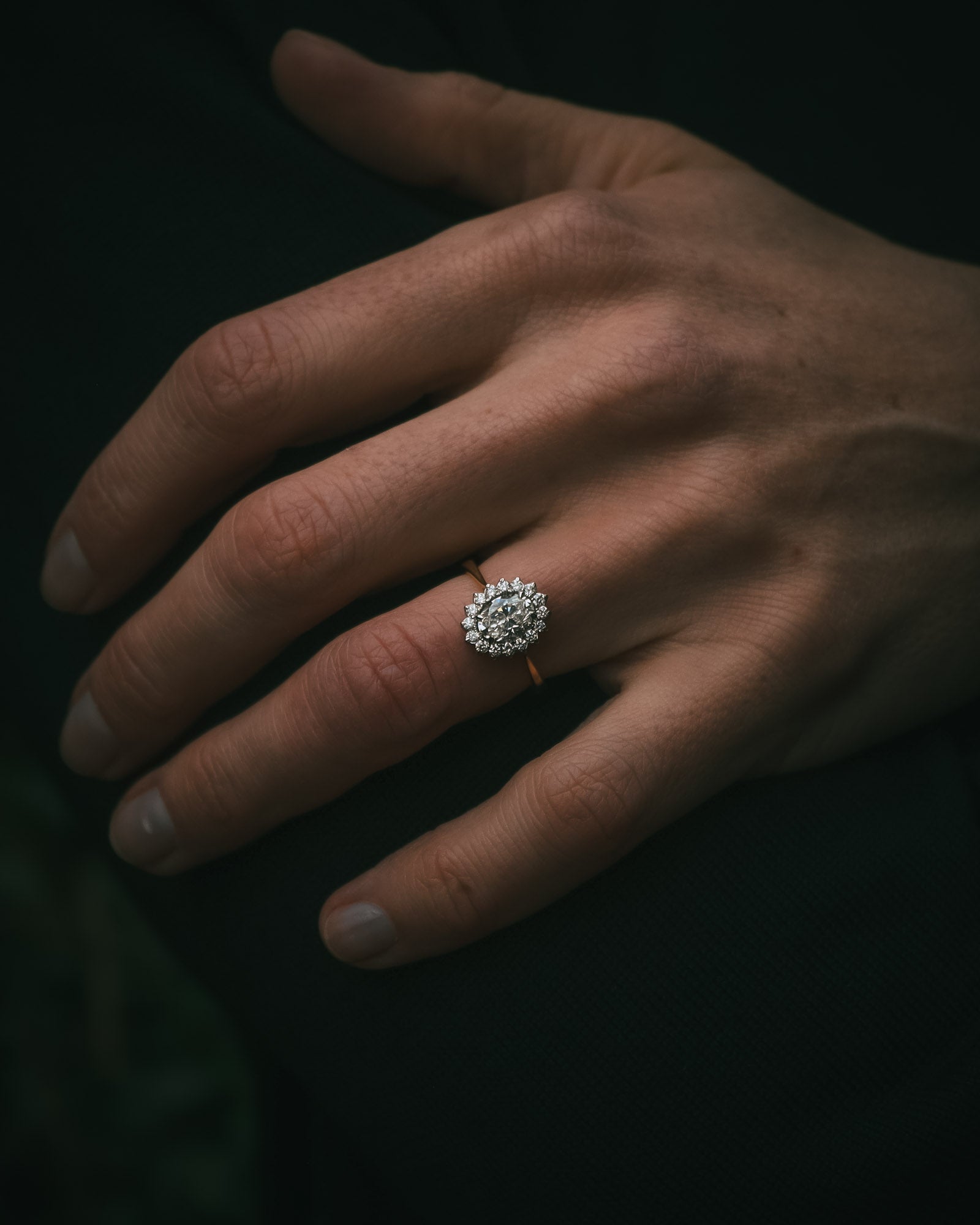 Flùr oval diamond cluster ring on hand; 1.00ct GIA certificated centre diamond