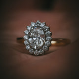 Flùr oval diamond cluster ring in 18ct yellow gold and platinum; front view in hand