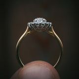 Flùr oval diamond cluster ring in 18ct yellow gold and platinum; profile with petal detailing