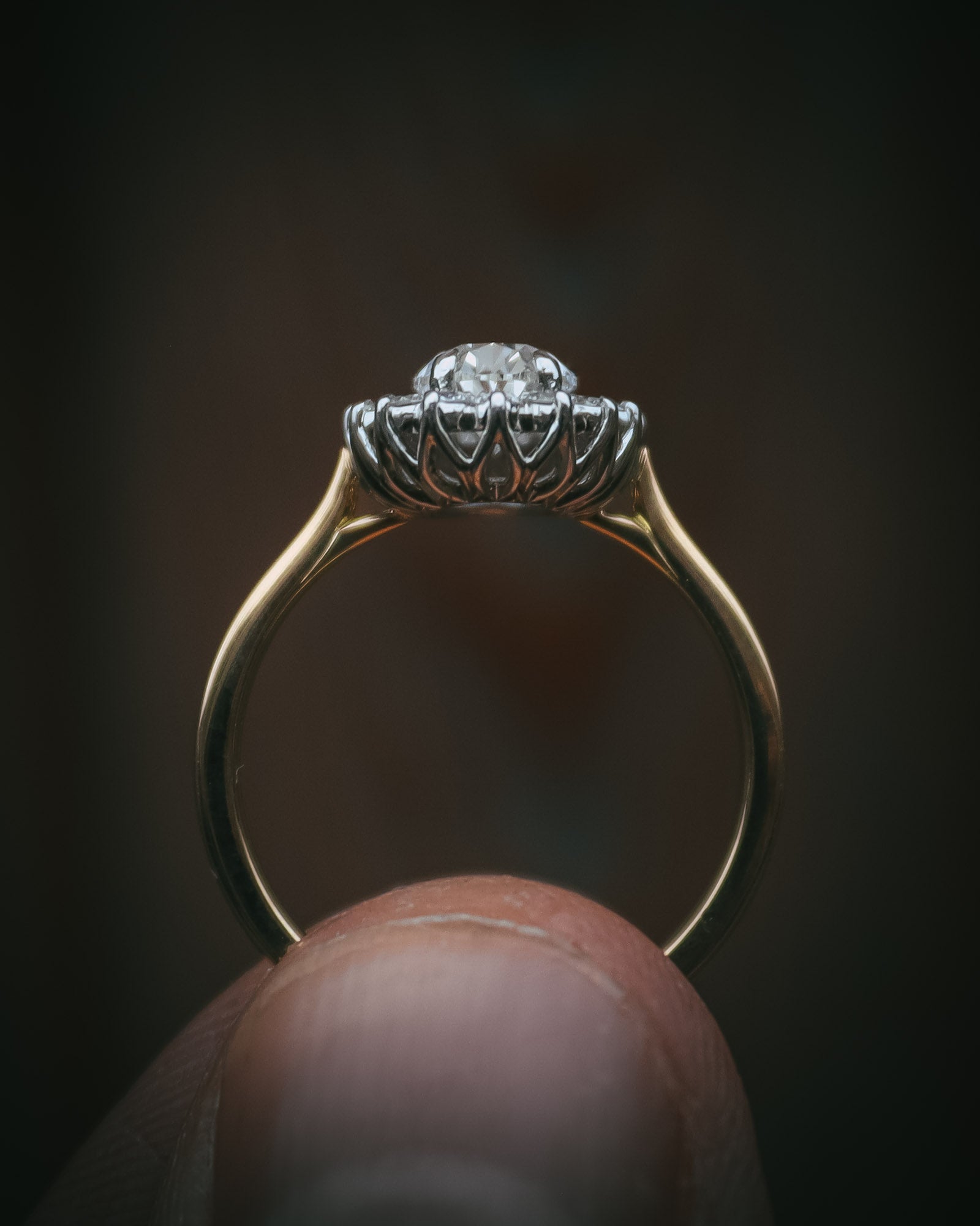 Flùr oval diamond cluster ring in 18ct yellow gold and platinum; profile with petal detailing