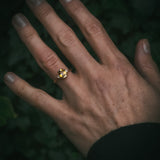 
Fidra bi-colour yellow and orange sapphire ring on hand; oval mixed-cut centre stone