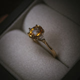 Fidra bi-colour yellow and orange sapphire ring in box; oval mixed-cut centre stone