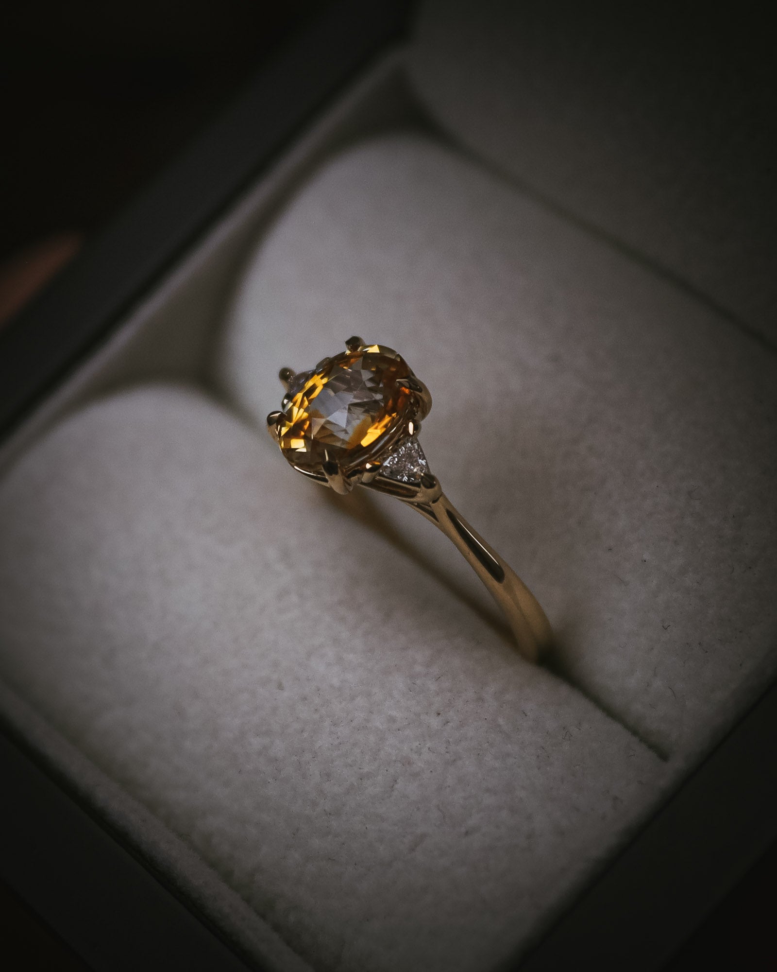 Fidra bi-colour yellow and orange sapphire ring in box; oval mixed-cut centre stone