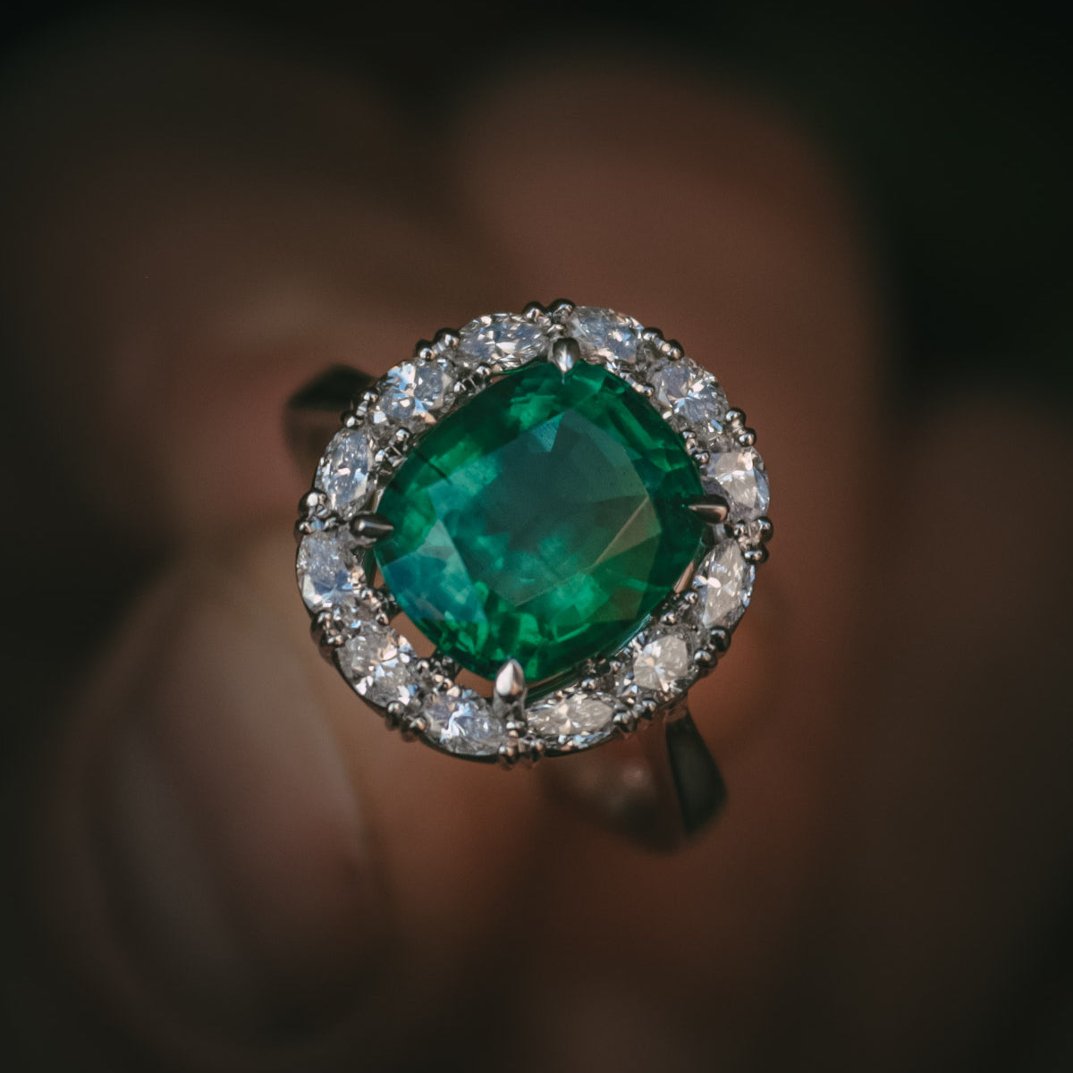 Emerald and diamond halo engagement ring natural gemstone detail