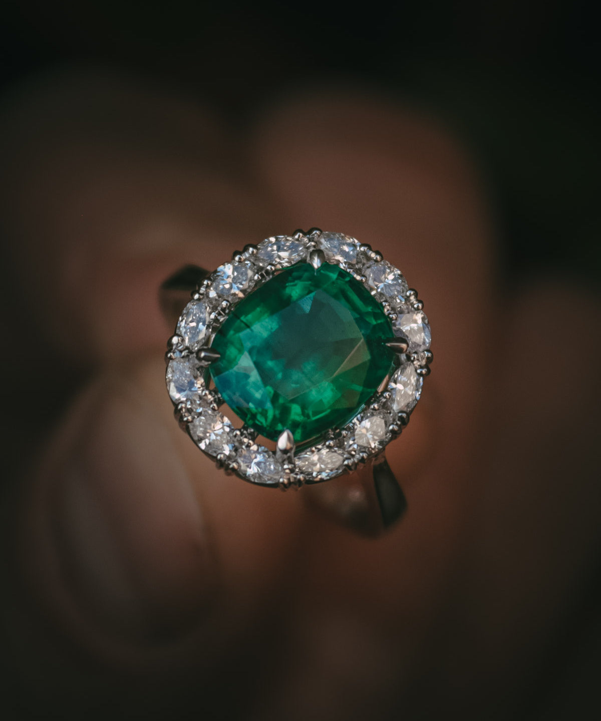 Emerald and diamond halo engagement ring natural gemstone detail