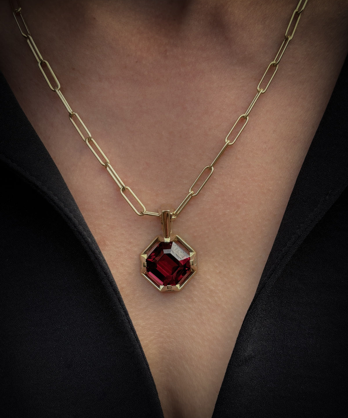 bespoke red garnet and diamond pendant on chunky gold chain worn on the chest